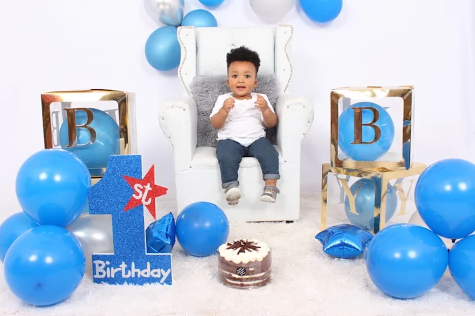 First birthday themed studio shoot with blue balloons and cake