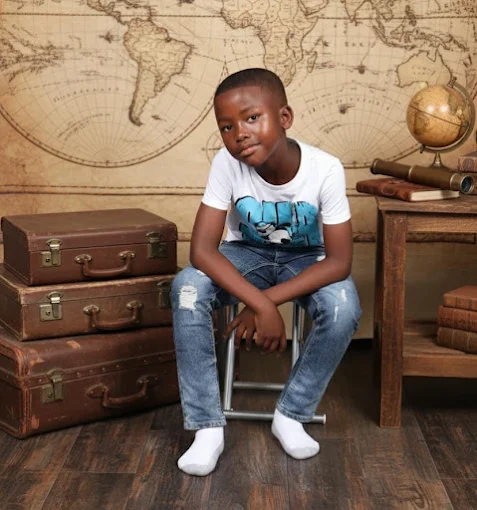 Child photographed on a vintage-styled set at PNS Photography Studio